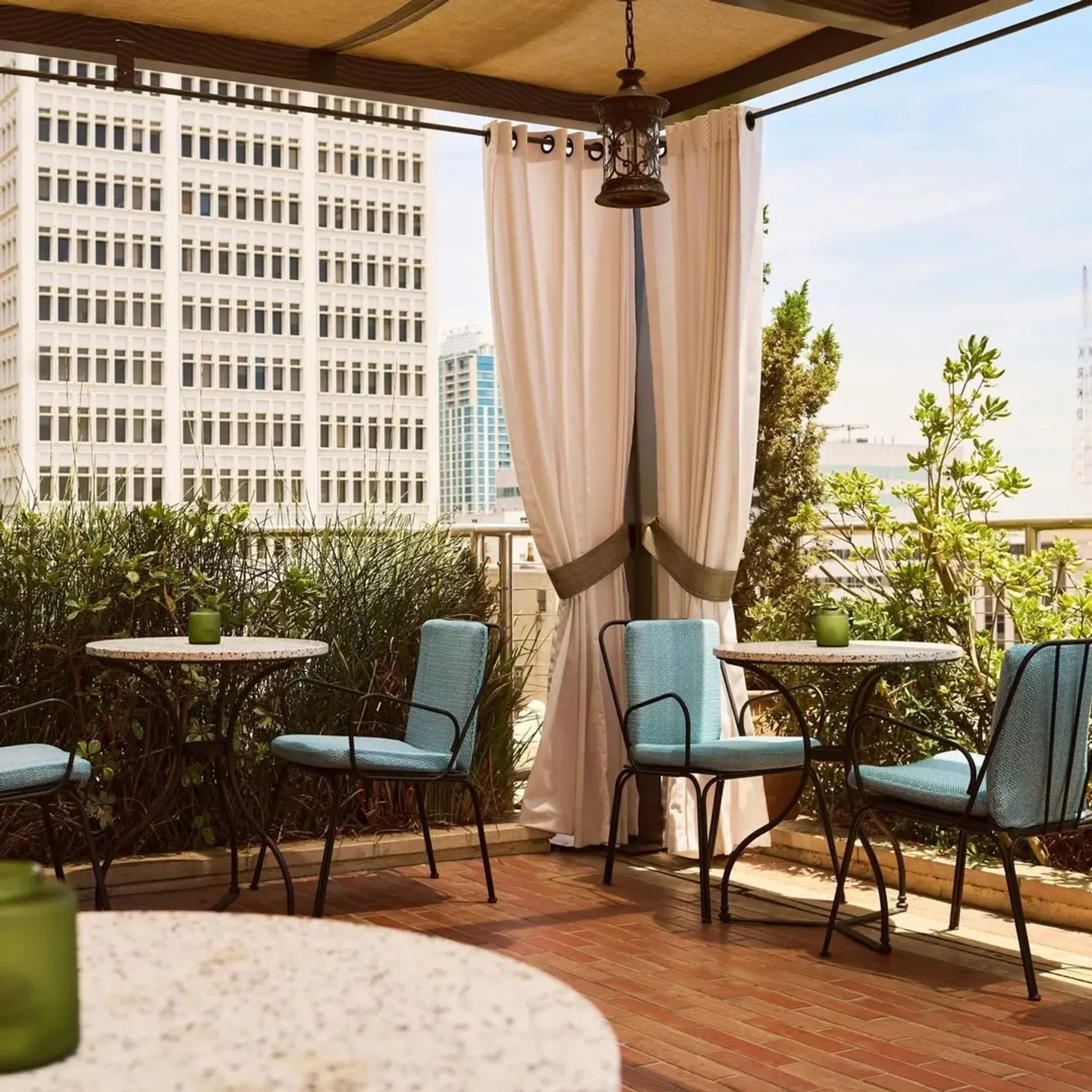 Outdoor seating at AC Rooftop Lounge in Los Angeles with city views and elegant decor