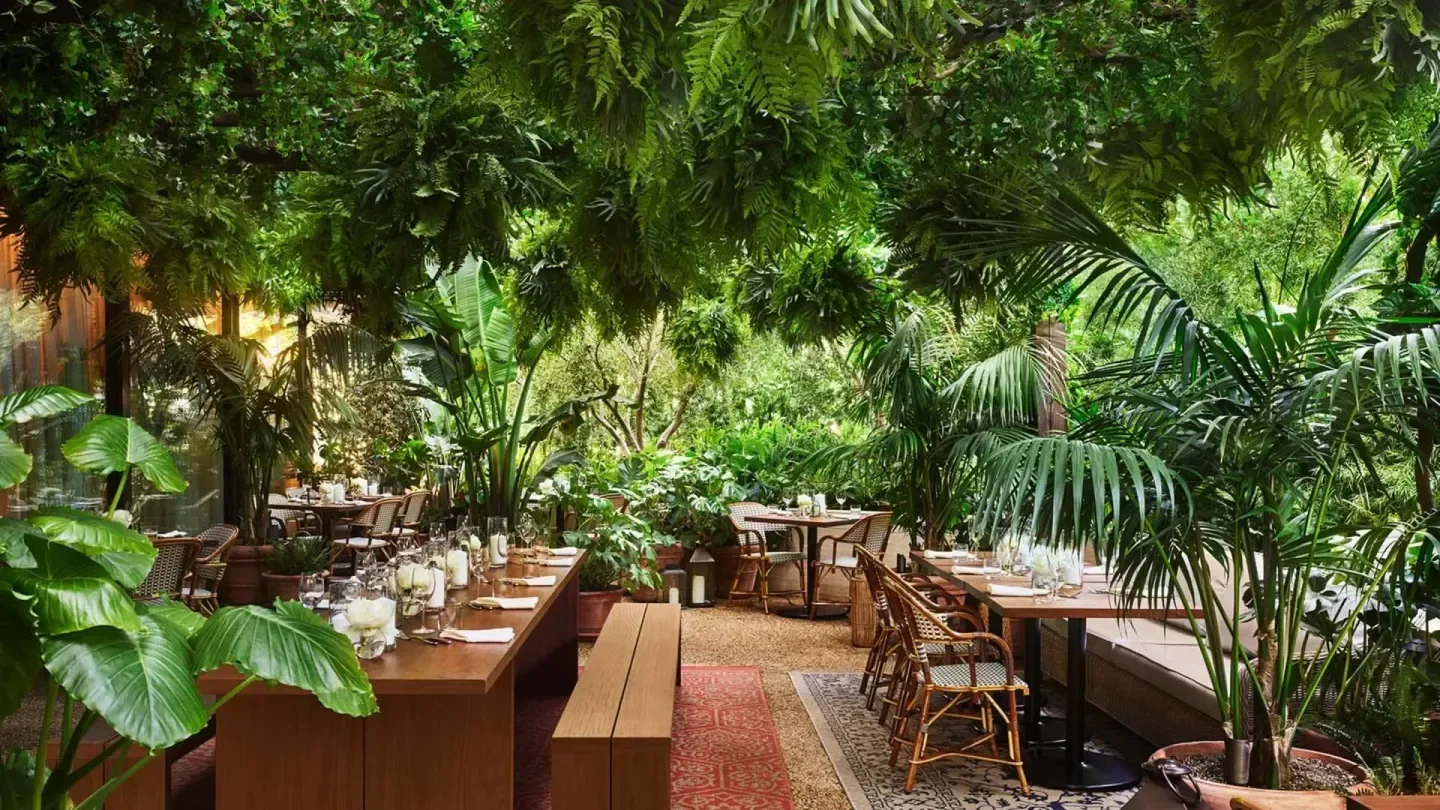 Ardor restaurant in Los Angeles with lush greenery and elegant dining setting.