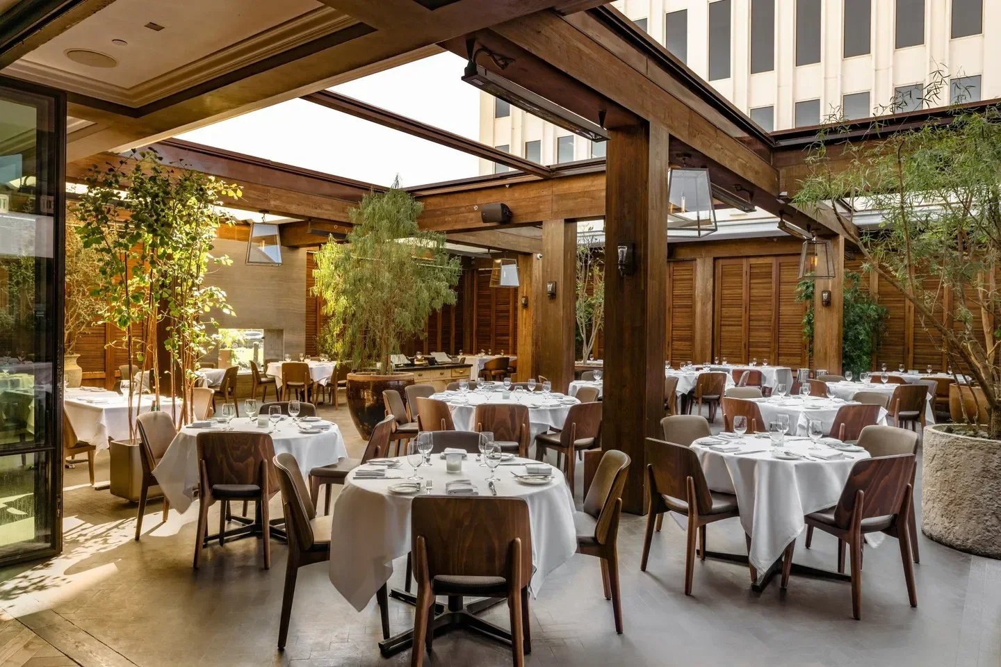 Elegant dining area at Baltaire Restaurant in Los Angeles, featuring wooden accents and tables