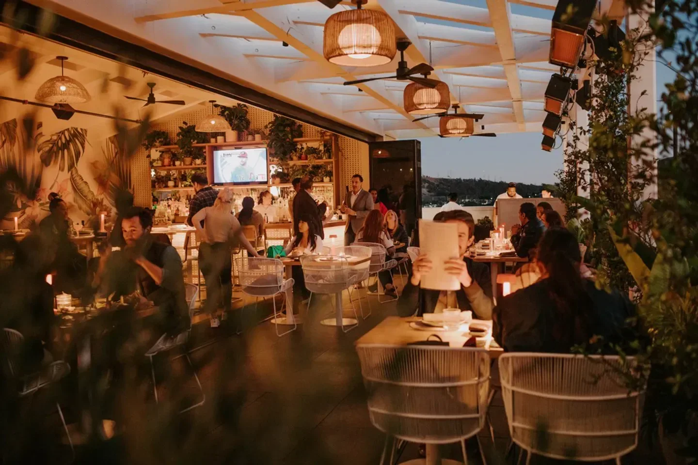 People dining at Canopy Club restaurant in Los Angeles, enjoying the outdoor space.