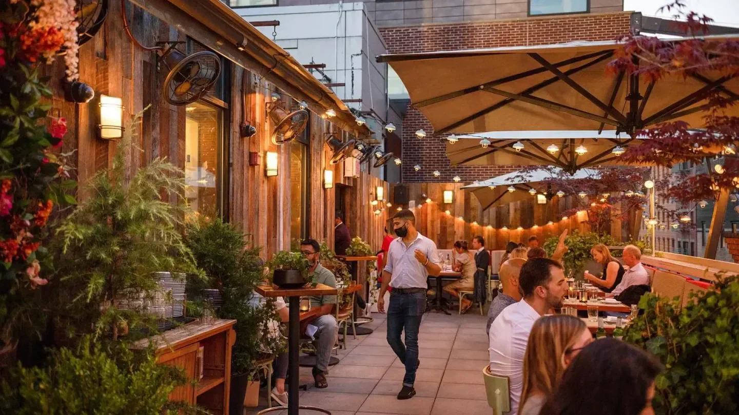 Outdoor patio at CATCH Los Angeles restaurant, featuring stylish decor and dining ambiance.