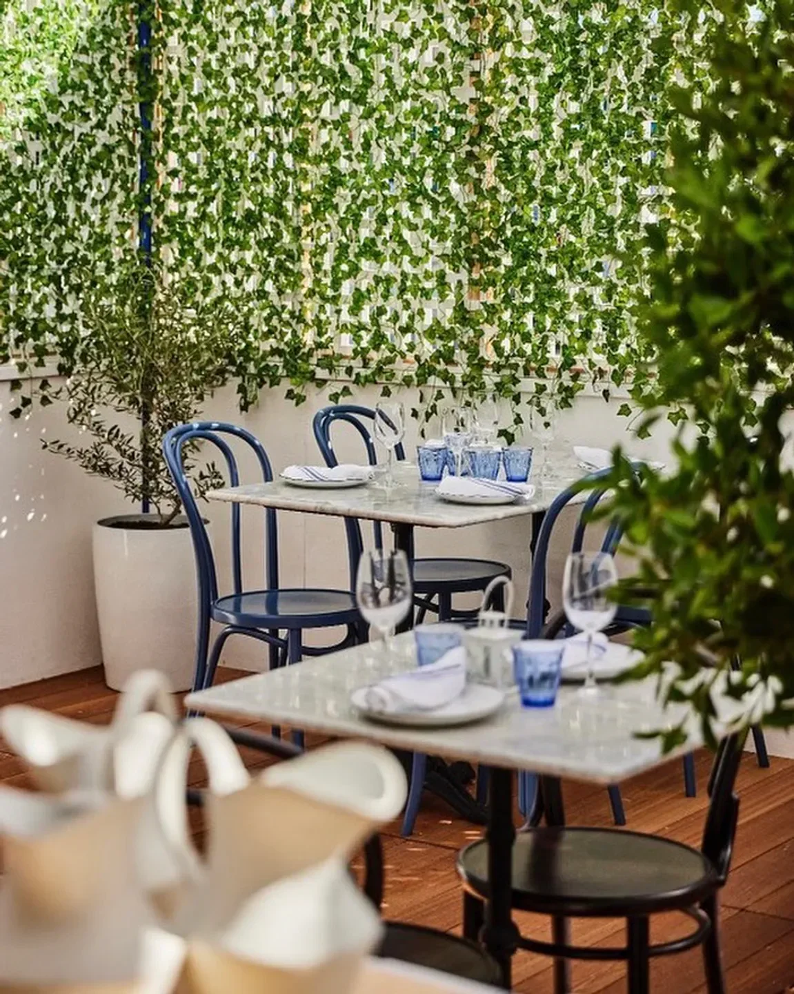 Freedman's restaurant in Los Angeles with outdoor dining area and lush green wall.