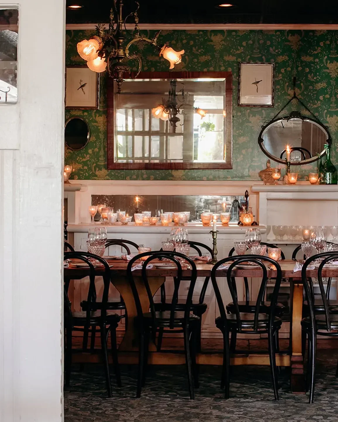 Cozy dining room at Hatchet Hall restaurant in Los Angeles with candlelit table setting.