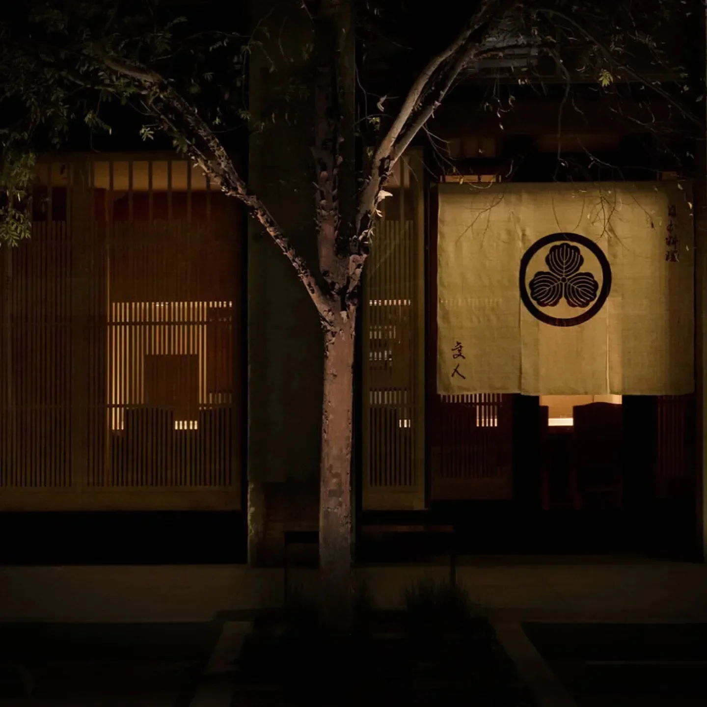 Entrance to Hayato in Los Angeles at night, with a traditional Japanese banner.