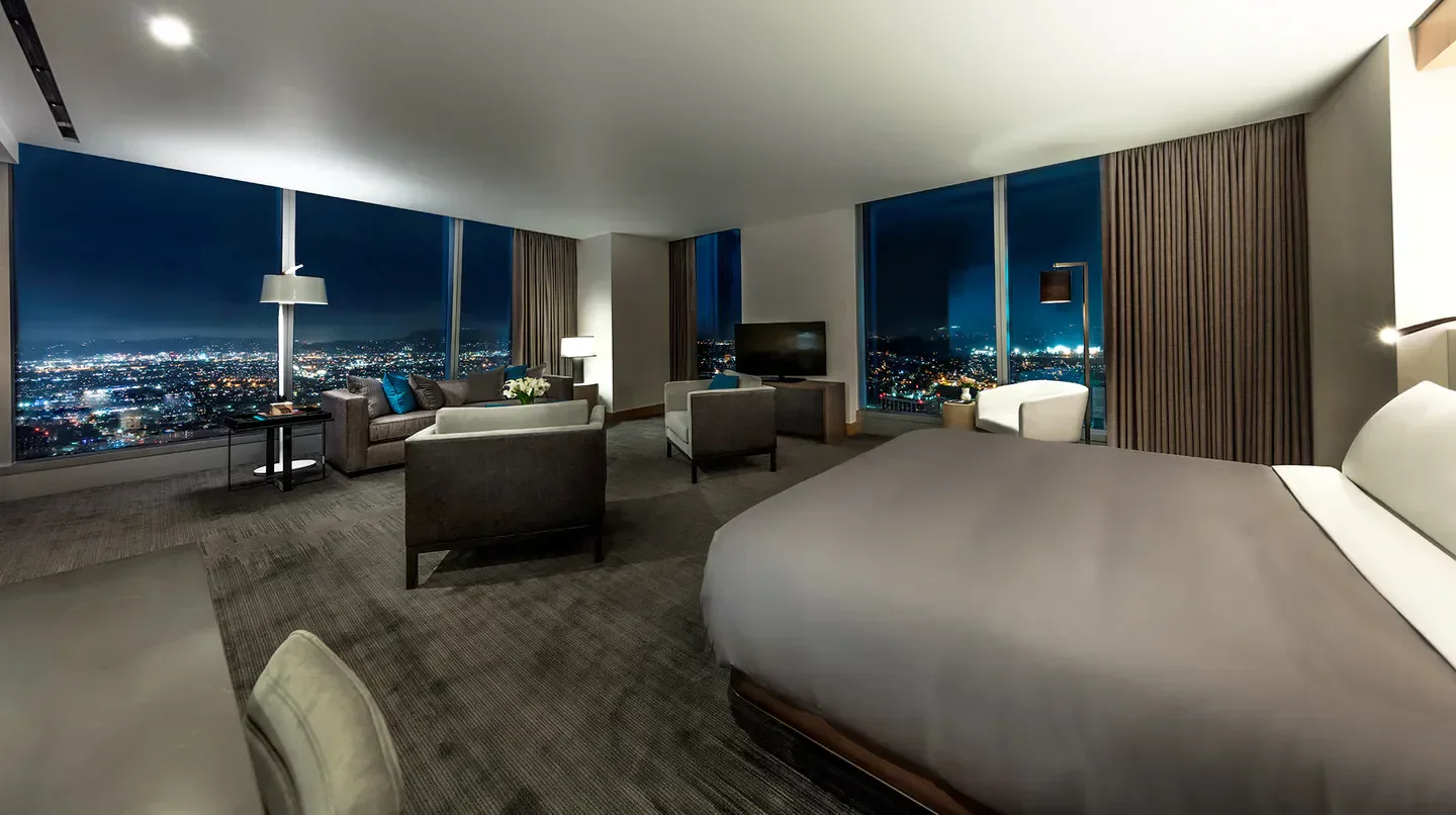Luxury suite with city views at night at the InterContinental Los Angeles Downtown hotel.