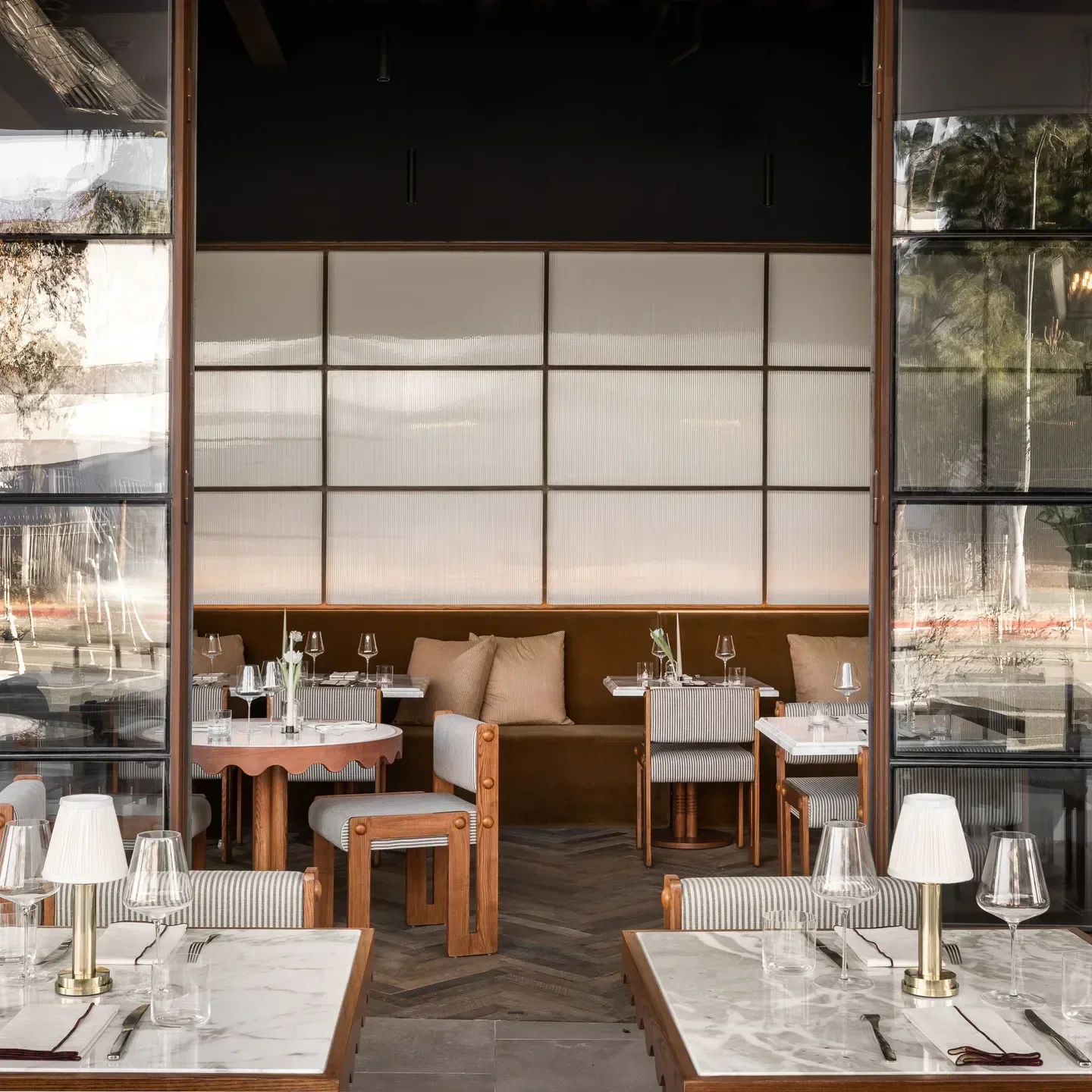 Interior dining at JULIET restaurant in Los Angeles, featuring stylish tables and decor.