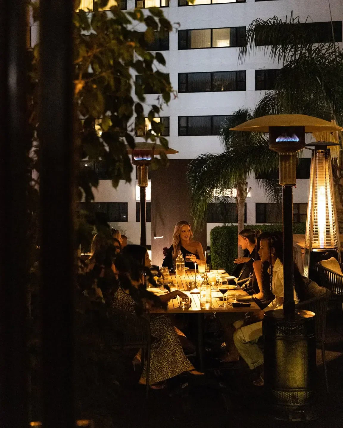 Outdoor dining at Katana Los Angeles, with warm lighting and a group of friends