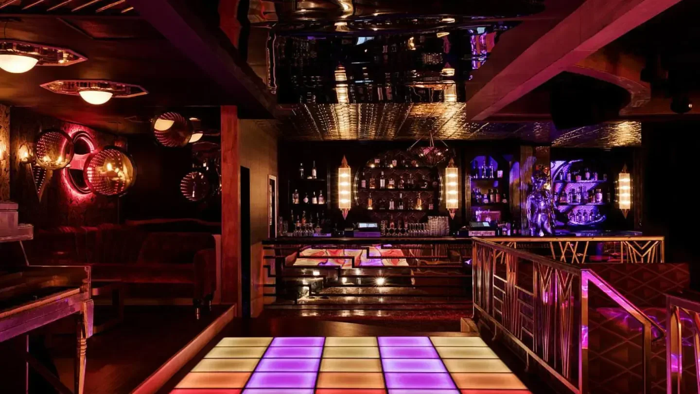 Interior of Kiss Kiss Bang Bang nightclub in Los Angeles with colorful dance floor.