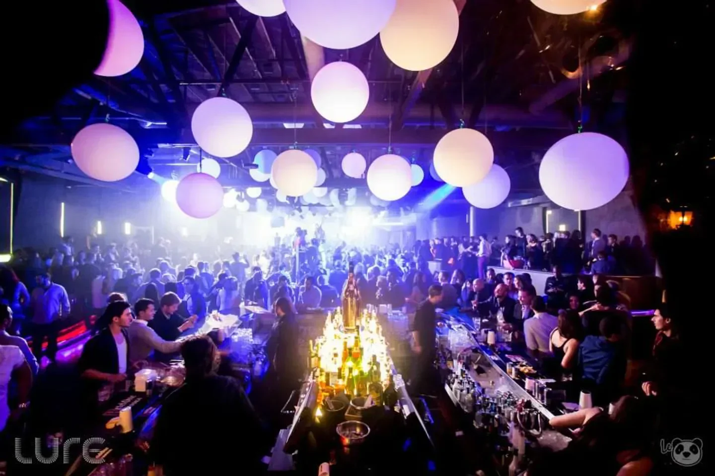 Inside Lure Nightclub in Los Angeles, packed with partygoers and lit with vibrant lights.
