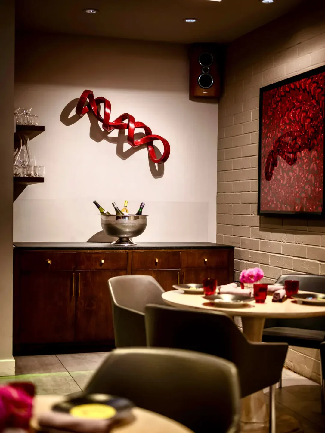 Interior of Mélisse Restaurant in Los Angeles, featuring art, tables, and wine