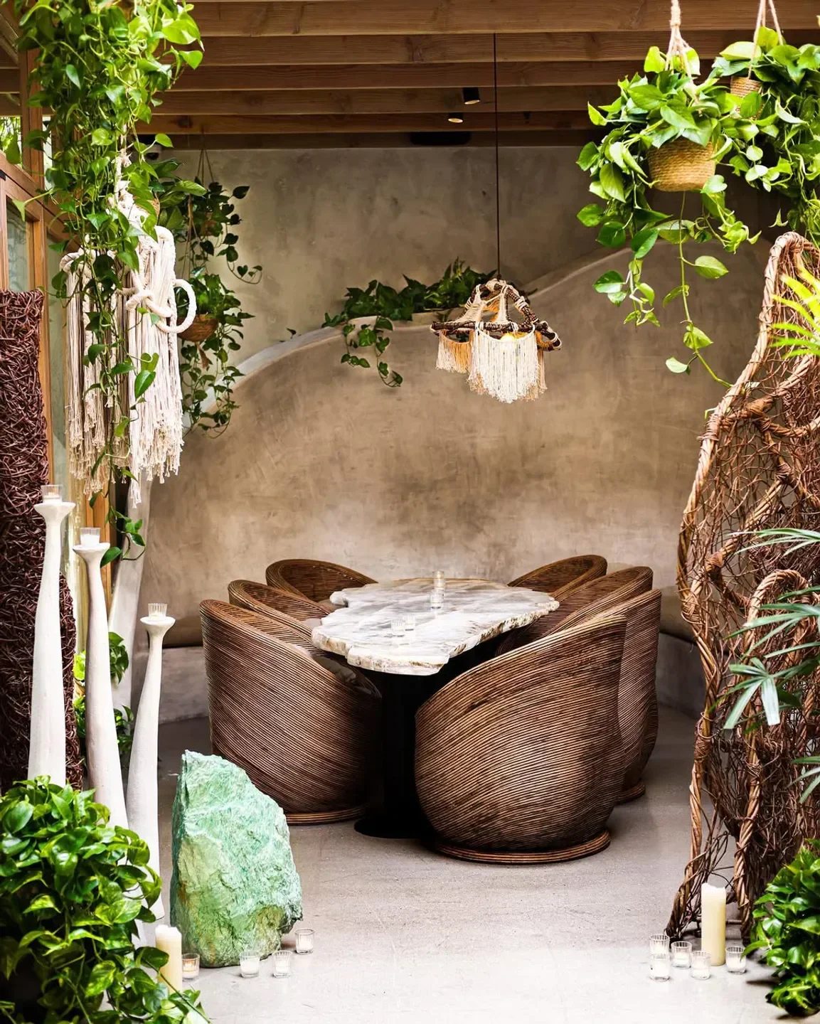 Cozy dining area at Meteora in Los Angeles, featuring unique chairs and natural decor.