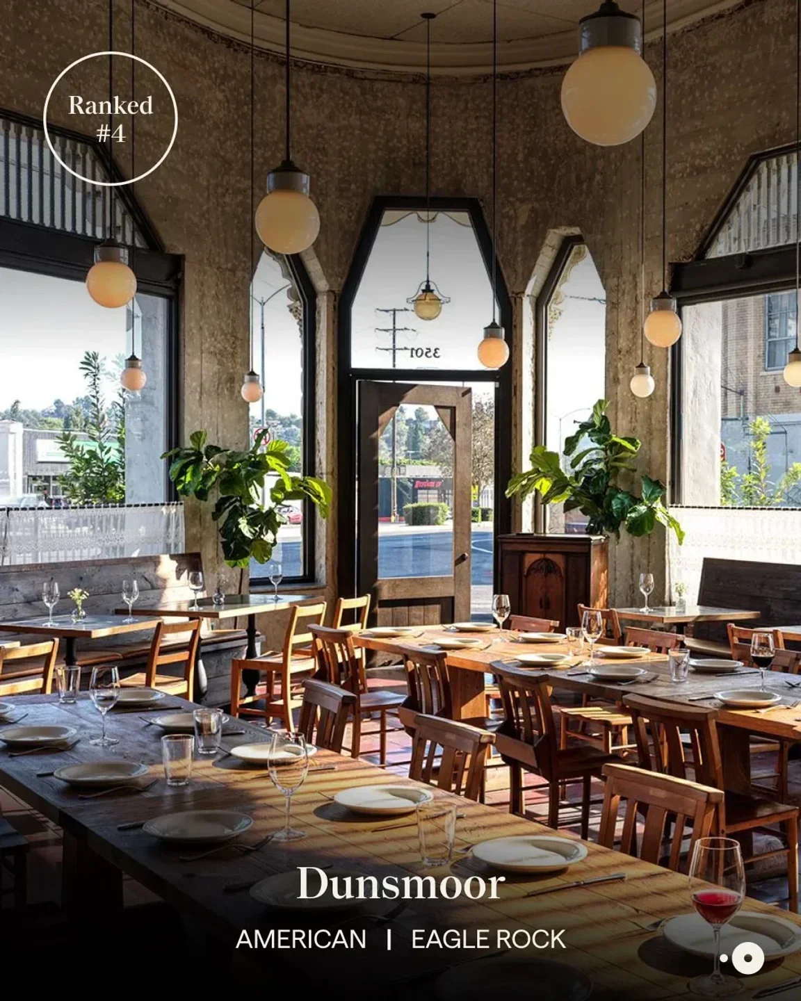 Interior of Morihiro restaurant in Los Angeles with wooden tables and elegant light fixtures.