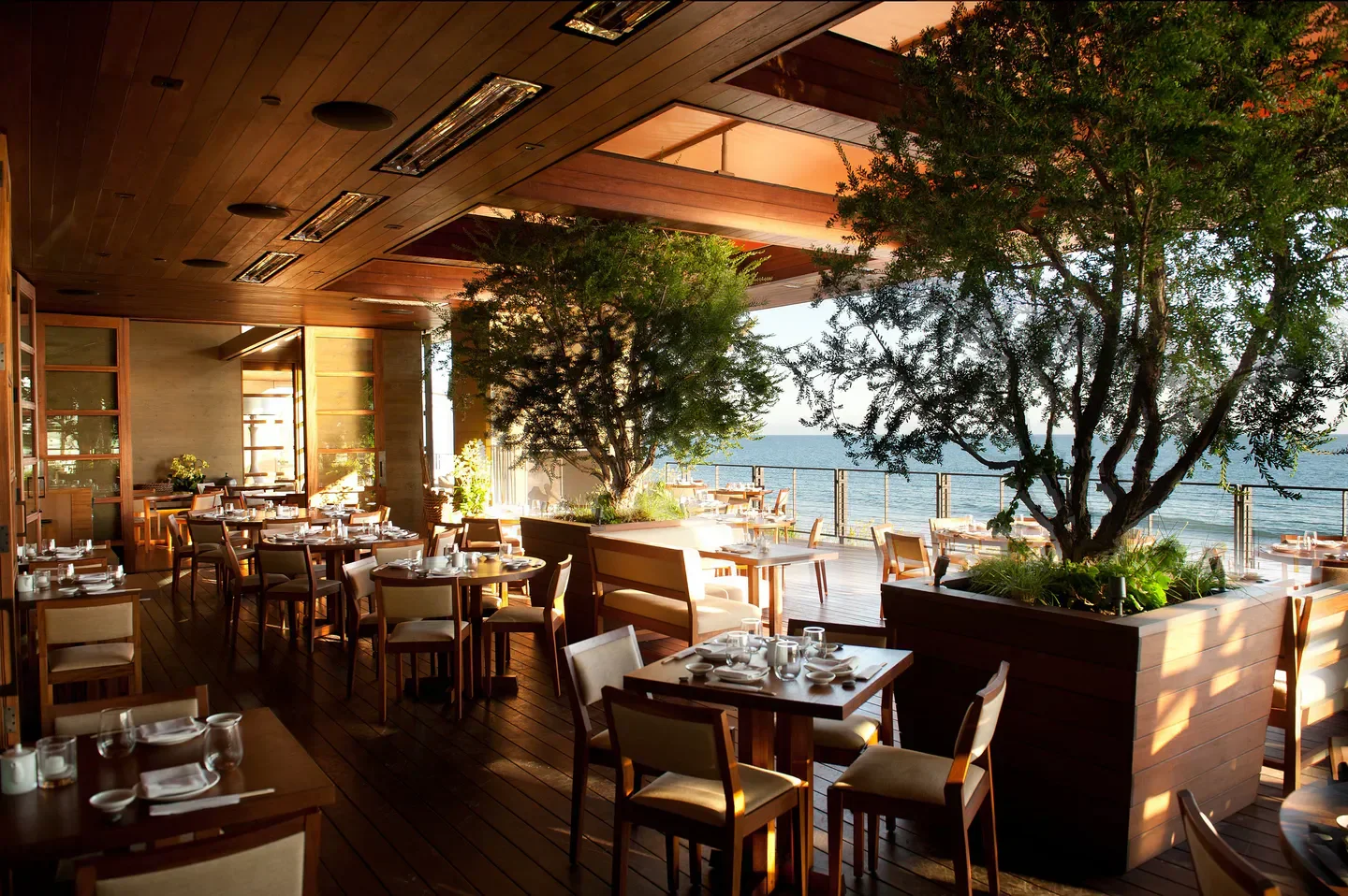 Outdoor dining at Nobu Malibu in Los Angeles, overlooking the ocean with stylish decor.