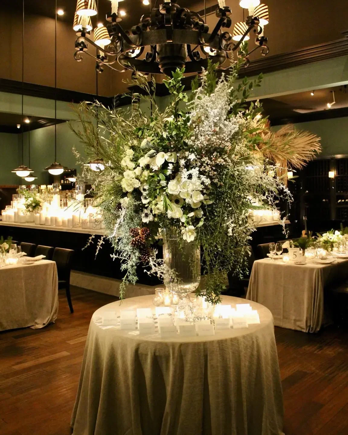 Elegant floral centerpiece at Osteria Mozza in Los Angeles, surrounded by candles.