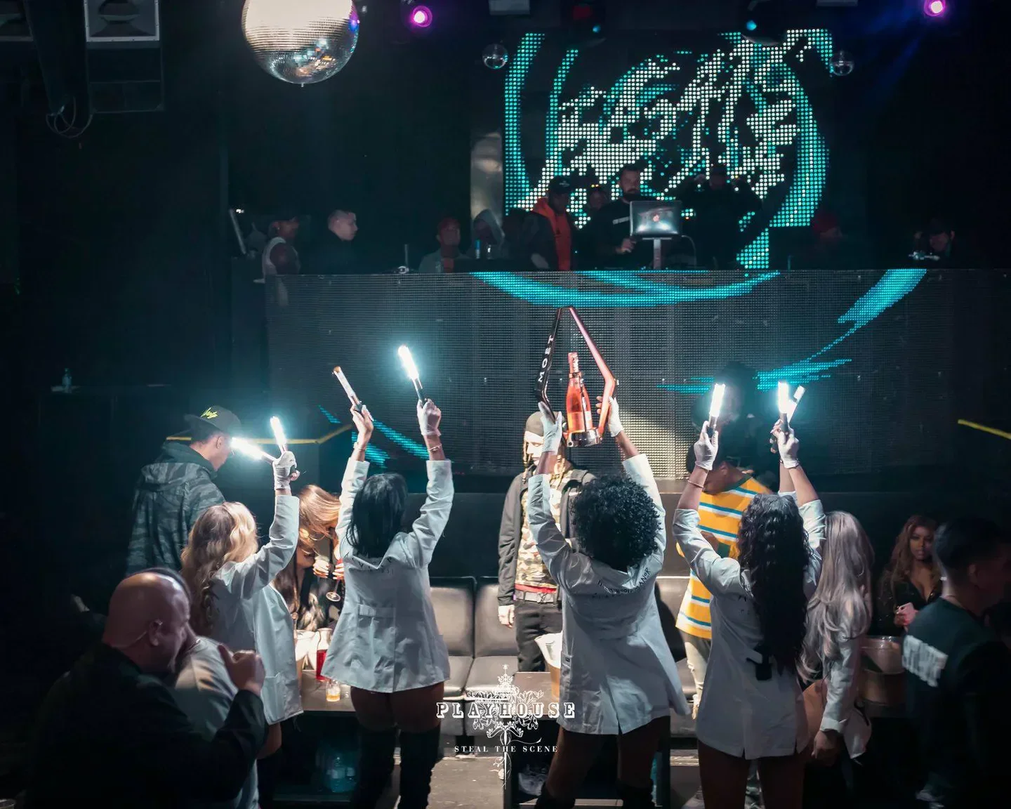 Playhouse Hollywood nightclub in Los Angeles with staff holding up champagne and lights.