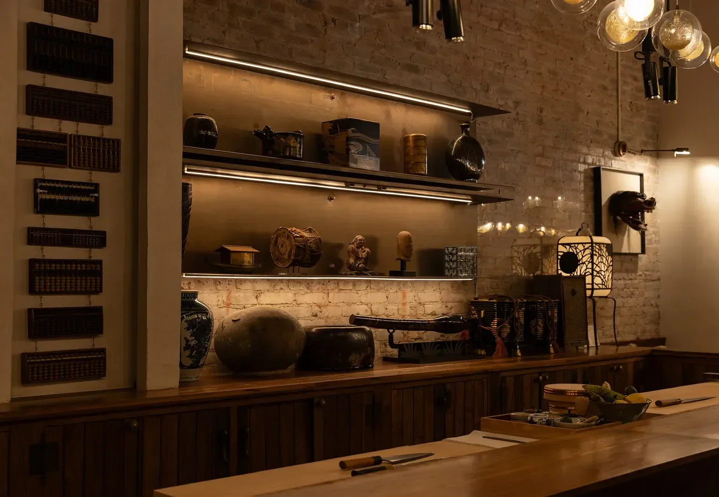 Interior design at Q Sushi in Los Angeles featuring decorative shelves and bar seating