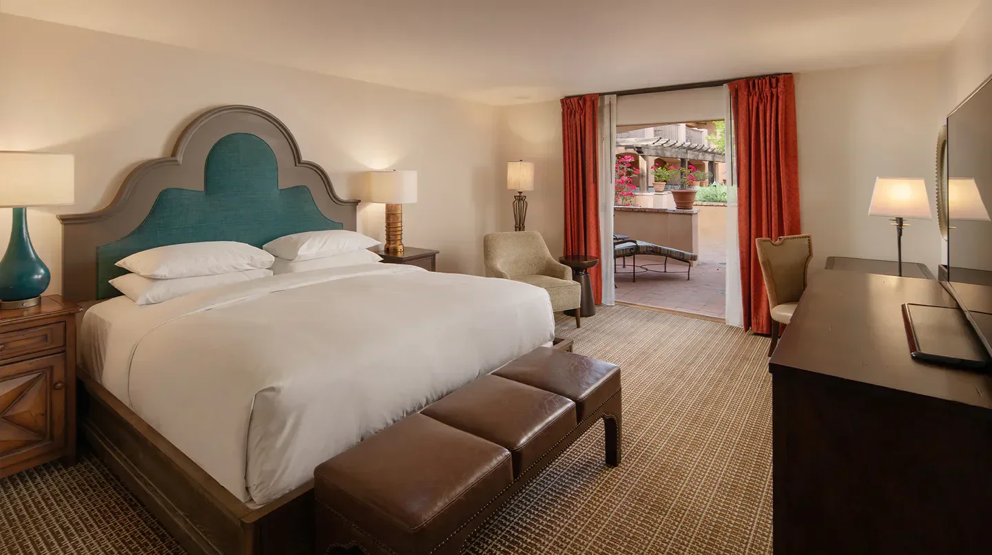 Cozy bedroom at the Royal Palms Resort and Spa in Arcadia, with outdoor patio access