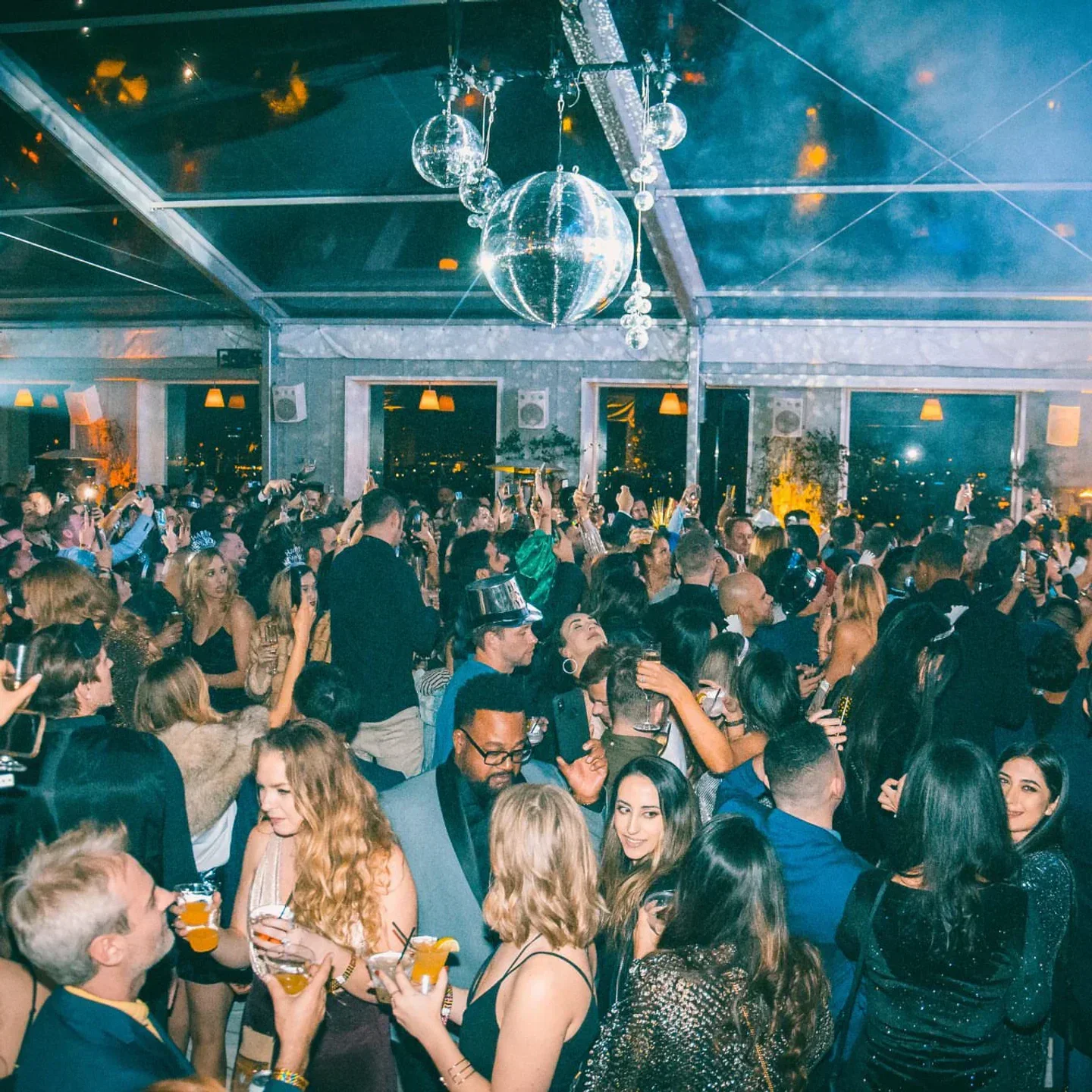 Party at Skybar Mondrian in Los Angeles with disco balls and a lively crowd.