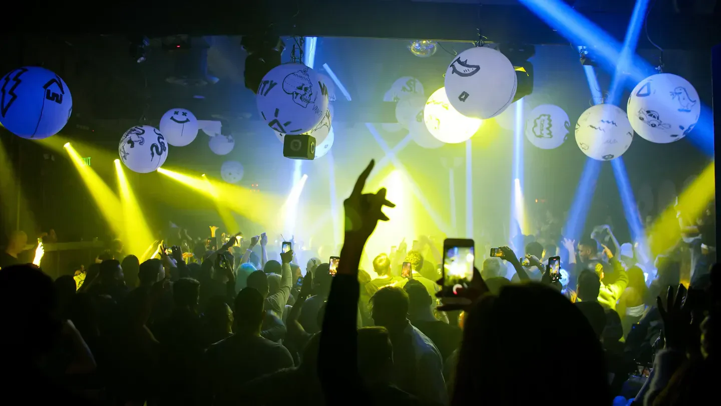 Energetic crowd at Sound Nightclub in Los Angeles with vibrant lights and decor.