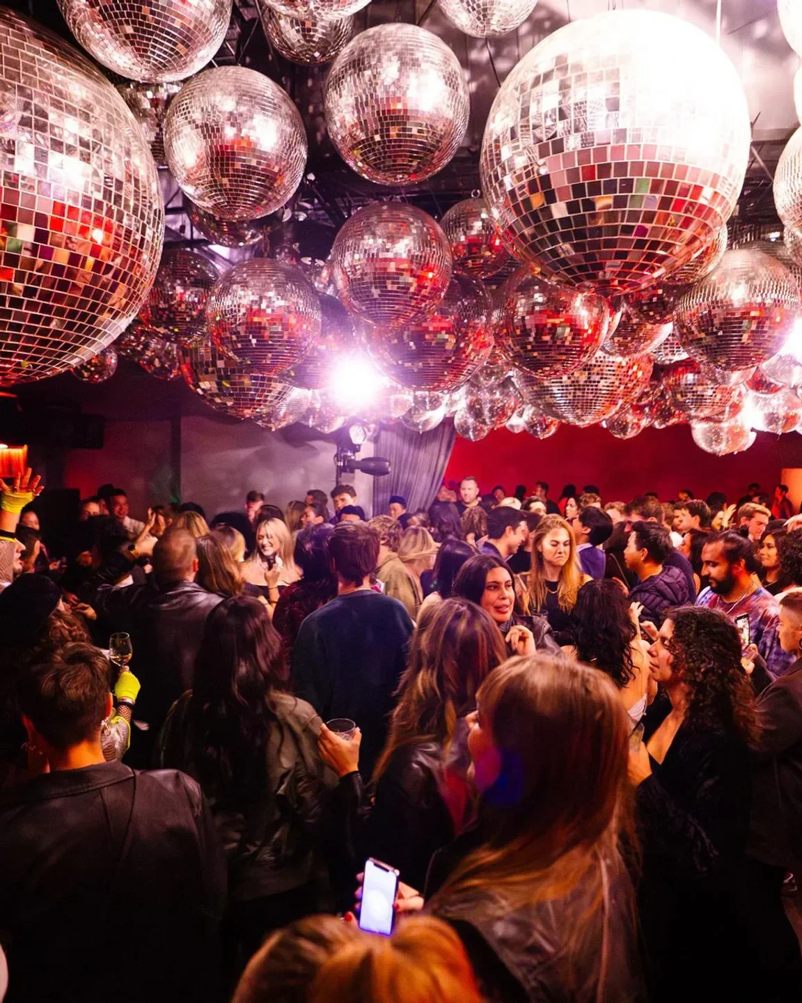 Disco balls and a lively crowd at Sunset at EDITION nightclub in Los Angeles