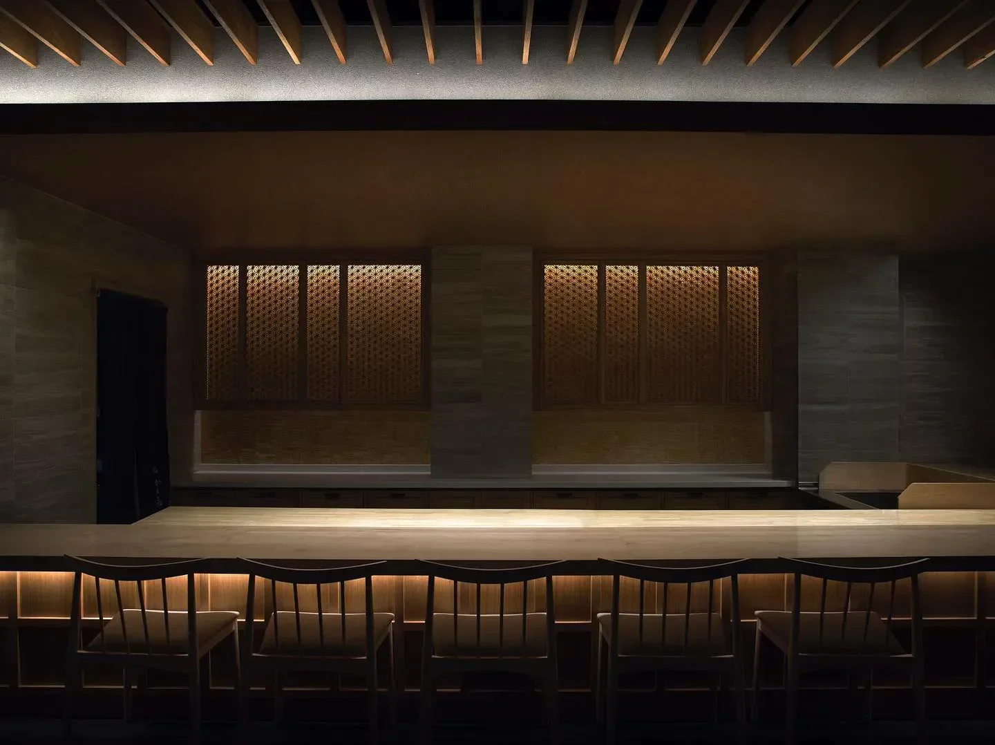 Interior view of Sushi Kaneyoshi in Los Angeles, featuring elegant wooden design and seating.