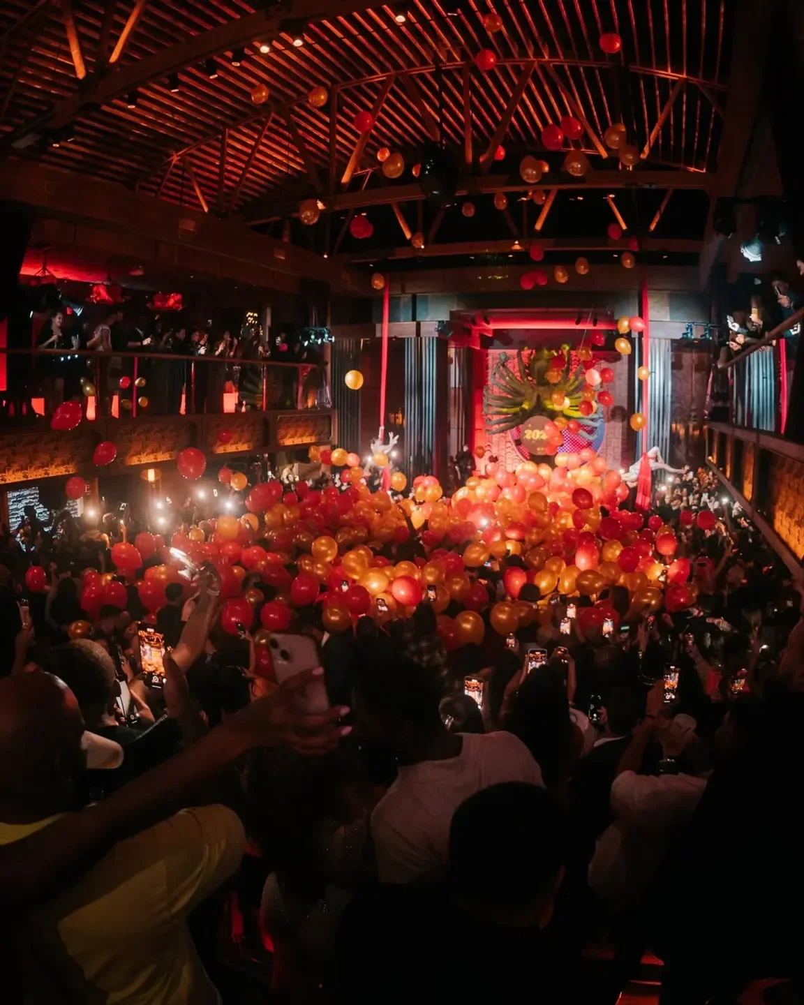 TAO Los Angeles: lively party with red and gold balloons and a crowded dance floor.