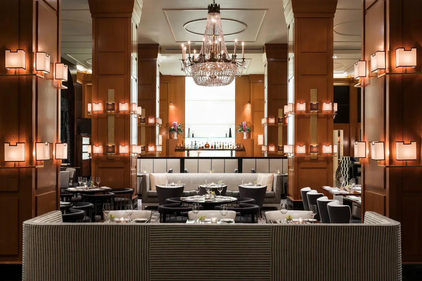 Elegant dining area at THE BLVD restaurant in Los Angeles, featuring a chandelier and stylish decor