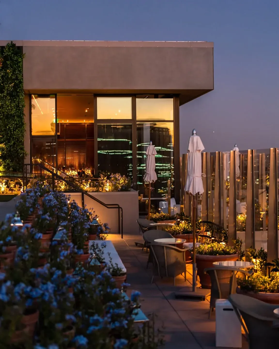 Rooftop dining at The Roof at EDITION in Los Angeles at dusk with city views
