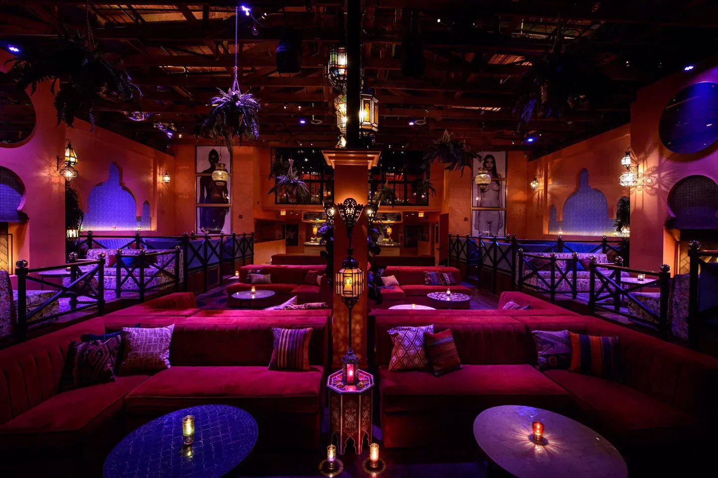 Warwick nightclub in Los Angeles, featuring plush red seating and Moroccan-inspired decor.